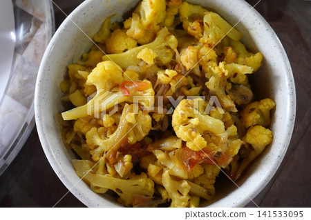 Delicious homestyle Indian cauliflower and tomato stir fry sabzi in a white bowl Delicious homestyle Indian cauliflower and tomato stir fry sabzi in a white bowl 141533095