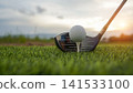 Golf clubs and balls on a green lawn in a beautiful golf course with morning sunshine. 141533100