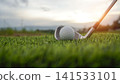 Golf clubs and balls on a green lawn in a beautiful golf course with morning sunshine. 141533101