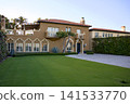 Mediterranean Villa With Moorish Arched Windows And Manicured Lawn 141533770