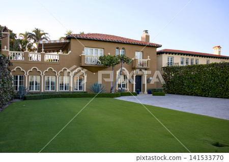 Mediterranean Villa With Moorish Arched Windows And Manicured Lawn 141533770
