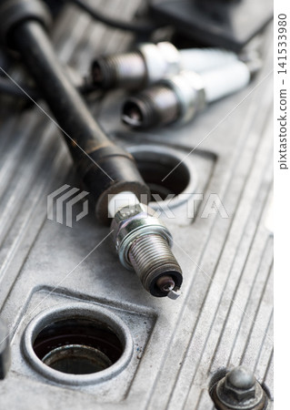 Spark Plugs on Car Engine During Automotive Maintenance Spark Plugs on Car Engine During Automotive Maintenance 141533980