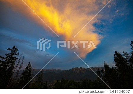 Colorful sunset sky. Amazing nature background. Evening adventure hiking 141534007