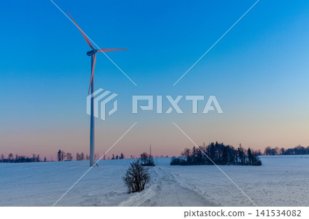 Wind Turbine in Snowy Rural Landscape at Winter Sunset Wind Turbine in Snowy Rural Landscape at Winter Sunset 141534082