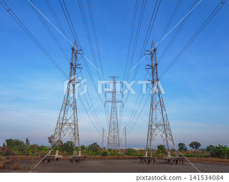Power Lines and Transmission Towers Under Blue Sky Power Lines and Transmission Towers Under Blue Sky 141534084