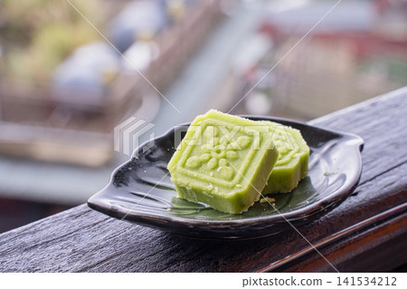 Green Matcha Mooncakes on Black Plate with Soft Bokeh Green Matcha Mooncakes on Black Plate with Soft Bokeh 141534212