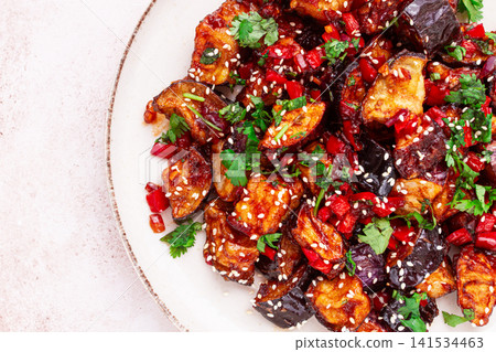 fried eggplant, Chinese style, in sweet and sour sauce, with pepper and sesame seeds. on a white plate, fried eggplant, Chinese style, in sweet and sour sauce, with pepper and sesame seeds. on a white plate, 141534463