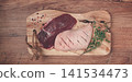 Fresh raw duck breasts, on a wooden chopping board, with herbs and spices, no people 141534473