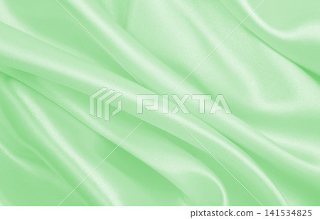 Smooth elegant green silk or satin luxury cloth texture as abstract background. Luxurious background design Smooth elegant green silk or satin luxury cloth texture as abstract background. Luxurious background design 141534825
