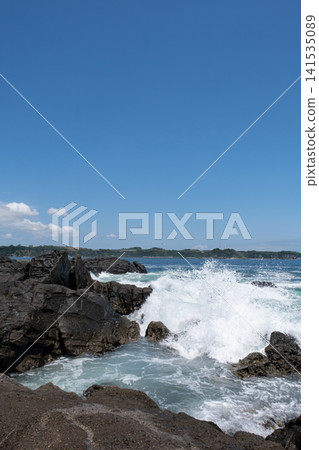 Rough waves crashing against the rocks of Jogashima Island on the Miura Peninsula, creating a sea spray. Rough waves crashing against the rocks of Jogashima Island on the Miura Peninsula, creating a sea spray. 141535089