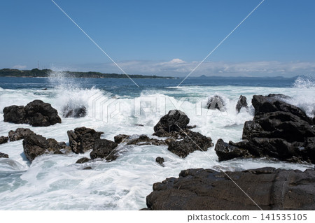 Rough waves crashing against the rocks of Jogashima Island on the Miura Peninsula, creating a sea spray. Rough waves crashing against the rocks of Jogashima Island on the Miura Peninsula, creating a sea spray. 141535105