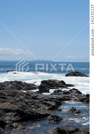 Rough waves crashing against the rocks of Jogashima Island on the Miura Peninsula, creating a sea spray. Rough waves crashing against the rocks of Jogashima Island on the Miura Peninsula, creating a sea spray. 141535137