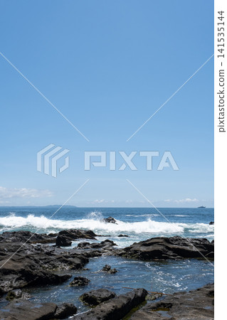 Rough waves crashing against the rocks of Jogashima Island on the Miura Peninsula, creating a sea spray. Rough waves crashing against the rocks of Jogashima Island on the Miura Peninsula, creating a sea spray. 141535144