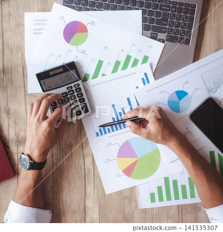 Overhead view of financial analysis with charts, calculator, and smartphone Overhead view of financial analysis with charts, calculator, and smartphone 141535307