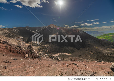 View of the Cerro Negro volcano surrounded by vegetation. Scenic view of Cerro Negro, Nicaragua View of the Cerro Negro volcano surrounded by vegetation. Scenic view of Cerro Negro, Nicaragua 141535507