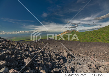 Beautiful view of a vegetated hill surrounded by volcanic rocks. Panoramic view from Cerro Negro, Nicaragua Beautiful view of a vegetated hill surrounded by volcanic rocks. Panoramic view from Cerro Negro, Nicaragua 141535530