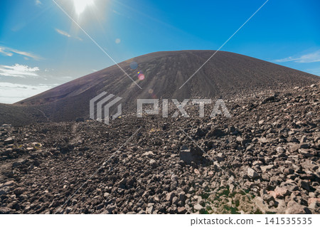 Panoramic view of a black hill surrounded by volcanic rocks. Panoramic view of the slopes of Cerro Negro Panoramic view of a black hill surrounded by volcanic rocks. Panoramic view of the slopes of Cerro Negro 141535535