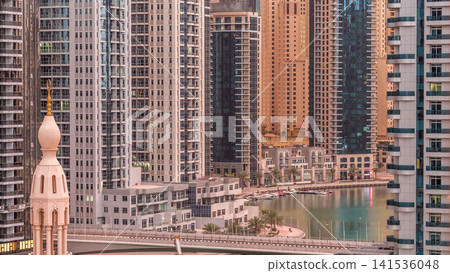 Dubai Marina skyscrapers and promenade aerial night to day timelapse, Dubai, United Arab Emirates Dubai Marina skyscrapers and promenade aerial night to day timelapse, Dubai, United Arab Emirates 141536048