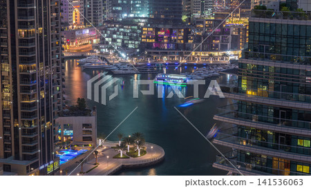 Aerial view of Dubai Marina residential and office skyscrapers with waterfront day to night timelapse Aerial view of Dubai Marina residential and office skyscrapers with waterfront day to night timelapse 141536063