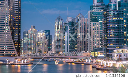 Dubai Marina towers and canal in Dubai day to night timelapse Dubai Marina towers and canal in Dubai day to night timelapse 141536106