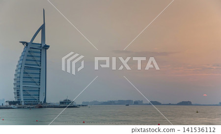 Dubai skyline with Burj Al Arab hotel during sunset timelapse. Dubai skyline with Burj Al Arab hotel during sunset timelapse. 141536112