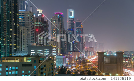 Downtown Dubai towers day to night timelapse. Aerial view of Sheikh Zayed road with skyscrapers after sunset. Downtown Dubai towers day to night timelapse. Aerial view of Sheikh Zayed road with skyscrapers after sunset. 141536119