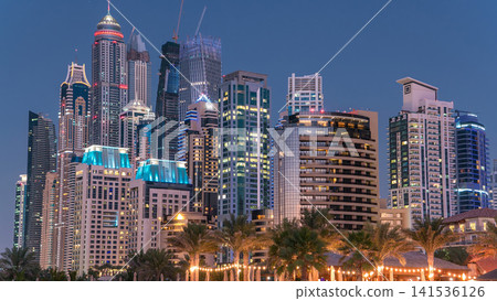 Modern skyscrapers day to night timelapse in jumeirah beach residence in Dubai, JBR Modern skyscrapers day to night timelapse in jumeirah beach residence in Dubai, JBR 141536126