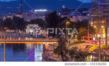 Aerial view along the Danube Canal in Vienna day to night timelapse after sunset Aerial view along the Danube Canal in Vienna day to night timelapse after sunset 141536260