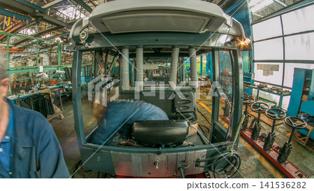 Conveyor assembly stage the body of tractor at big industrial factory timelapse Conveyor assembly stage the body of tractor at big industrial factory timelapse 141536282