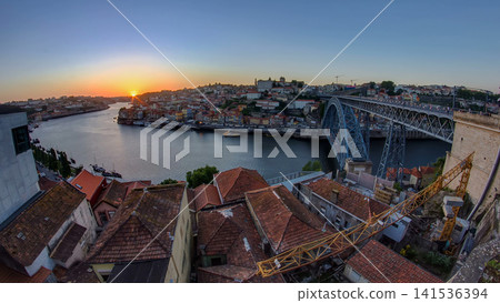 Panorama of old city Porto at river Duoro,with Port transporting boats at sunset timelapse, Oporto, Portugal Panorama of old city Porto at river Duoro,with Port transporting boats at sunset timelapse, Oporto, Portugal 141536394