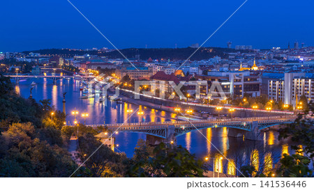 Aerial evening view of the Vltava River and illuminated bridges day to night timelapse, Prague Aerial evening view of the Vltava River and illuminated bridges day to night timelapse, Prague 141536446