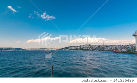 Ferry boat leaving from Galata Bridge at evening tome from european to asian part of Istanbul timelapse view from ship. Ferry boat leaving from Galata Bridge at evening tome from european to asian part of Istanbul timelapse view from ship. 141536489