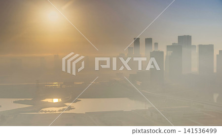 Abu Dhabi city skyline with skyscrapers at sunrise from above timelapse Abu Dhabi city skyline with skyscrapers at sunrise from above timelapse 141536499