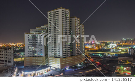 Cityscape with towers in Ajman from rooftop day to night timelapse. United Arab Emirates. Cityscape with towers in Ajman from rooftop day to night timelapse. United Arab Emirates. 141536517