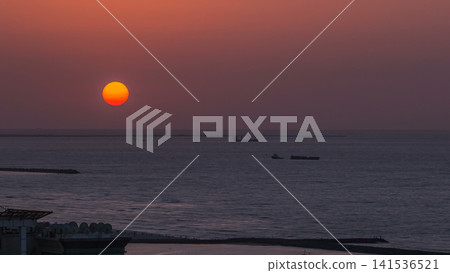 Sunset in Ajman aerial view from rooftop timelapse. United Arab Emirates. Sunset in Ajman aerial view from rooftop timelapse. United Arab Emirates. 141536521