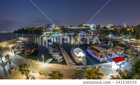Aerial view of yacht harbor and red house roofs in Old town day to night timelapse Antalya, Turkey. Aerial view of yacht harbor and red house roofs in Old town day to night timelapse Antalya, Turkey. 141536533