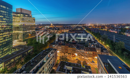 Aerial day to night timelapse of Brussels urban landscape blending office skyscrapers with residential areas. Aerial day to night timelapse of Brussels urban landscape blending office skyscrapers with residential areas. 141536563