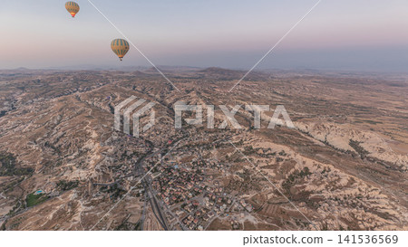 Aerial view from hot air balloon during Sunrise over the fairytale landscape hills of Kapadokya timelapse hyperlapse with morning light. 141536569