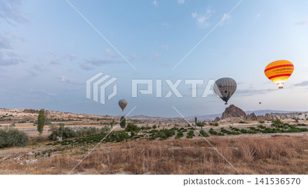 Beautiful colorful hot air balloons take off and flying in clear morning sky timelapse in Cappadocia, Turkey Beautiful colorful hot air balloons take off and flying in clear morning sky timelapse in Cappadocia, Turkey 141536570
