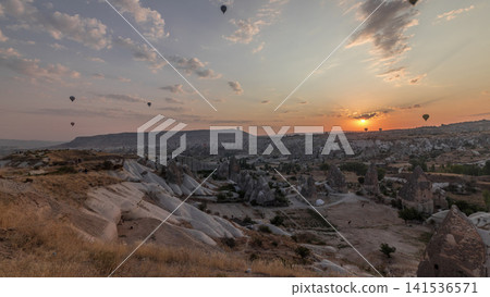 Beautiful sunrise with colorful hot air balloons take off and flying in clear morning sky aerial timelapse in Cappadocia, Turkey Beautiful sunrise with colorful hot air balloons take off and flying in clear morning sky aerial timelapse in Cappadocia, Turkey 141536571