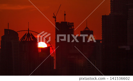 Dubai Marina skyscrapers from golf course sunset timelapse, Dubai, United Arab Emirates Dubai Marina skyscrapers from golf course sunset timelapse, Dubai, United Arab Emirates 141536602