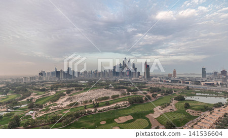 Dubai Marina skyscrapers and golf course night to day timelapse, Dubai, United Arab Emirates Dubai Marina skyscrapers and golf course night to day timelapse, Dubai, United Arab Emirates 141536604