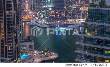 Aerial view of Dubai Marina residential and office skyscrapers with waterfront day to night timelapse Aerial view of Dubai Marina residential and office skyscrapers with waterfront day to night timelapse 141536611