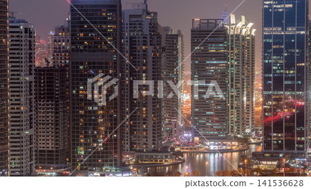 Residential and office buildings in Jumeirah lake towers district day to night timelapse in Dubai Residential and office buildings in Jumeirah lake towers district day to night timelapse in Dubai 141536628