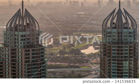 Dubai Marina skyscrapers and jumeirah lake towers view from the top aerial timelapse in the United Arab Emirates. Dubai Marina skyscrapers and jumeirah lake towers view from the top aerial timelapse in the United Arab Emirates. 141536635