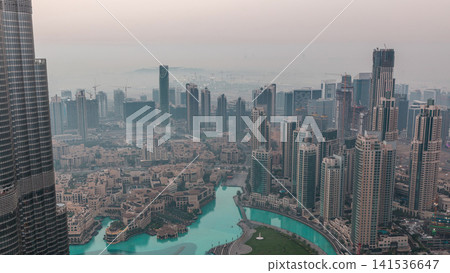 Amazing aerial view of Dubai downtown skyscrapers night to day timelapse, Dubai, United Arab Emirates Amazing aerial view of Dubai downtown skyscrapers night to day timelapse, Dubai, United Arab Emirates 141536647