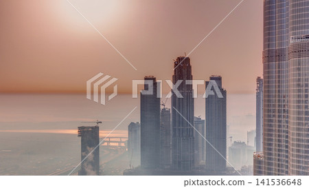 Amazing sunrise aerial view of Dubai downtown skyscrapers morning timelapse, Dubai, United Arab Emirates Amazing sunrise aerial view of Dubai downtown skyscrapers morning timelapse, Dubai, United Arab Emirates 141536648