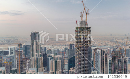 Amazing aerial view of Dubai downtown skyscrapers night to day timelapse, Dubai, United Arab Emirates 141536649