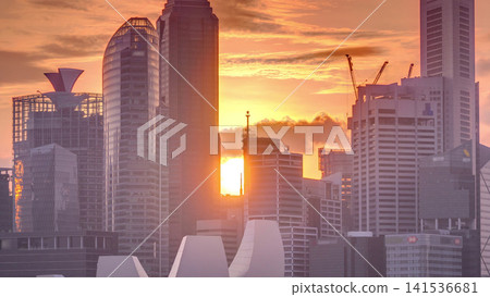 Sunset over the downtown skyline of Singapore as viewed from across the water from The Garden East timelapse. Singapore. Sunset over the downtown skyline of Singapore as viewed from across the water from The Garden East timelapse. Singapore. 141536681