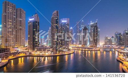 Beautiful aerial top view day to night transition timelapse of Dubai Marina canal 141536720